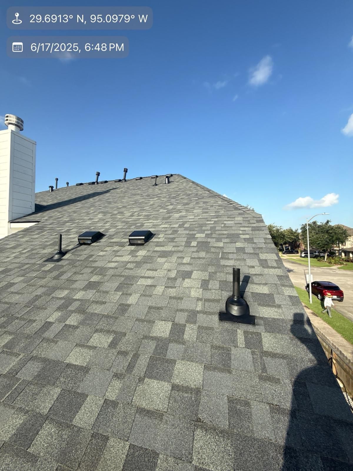 Side angle of the asphalt shingle roof before project completion in Houston
